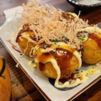 Takoyaki · Five pieces. Battered octopus ball with Japanese mayo, eel sauce, and bonito flakes.
