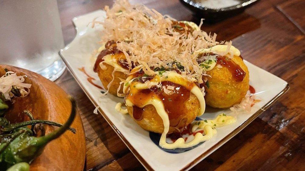 Takoyaki · Five pieces. Battered octopus ball with Japanese mayo, eel sauce, and bonito flakes.