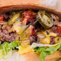 Wild Fire · House-ground beef patty, Texas asada (cheesesteak w/ onions, peppers, ‘shrooms), cheese sauc...