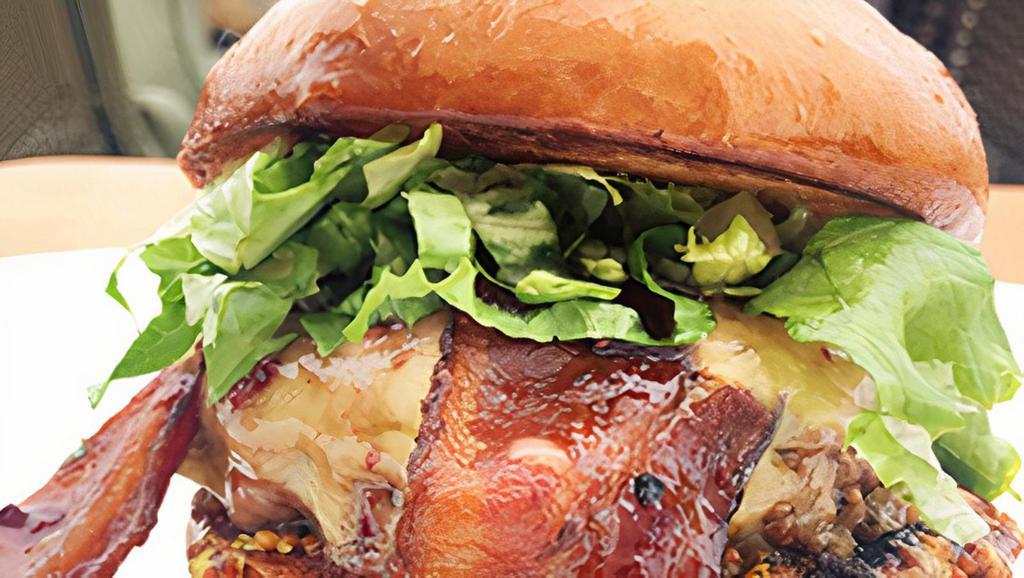 Whiskey Burger · House-ground beef patty, Irish whiskey cheddar, candied bacon, blackberry compote, shredded lettuce, whole-grain mustard, all on a brioche bun
