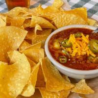 Brisket Chili Bowl · Our homemade chili topped with cheddar and jalapeños - served with tostada chips