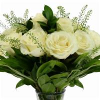 Unforgettable Arrangement (White) · A Dozen White Roses with greenery and filler in a clear vase.