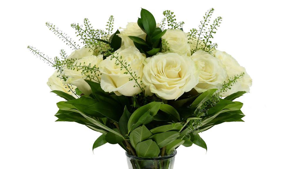 Unforgettable Arrangement (White) · A Dozen White Roses with greenery and filler in a clear vase.