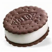 Dq® Sandwich · Cold, creamy DQ® vanilla soft serve, nestled between two chocolate flavored wafers.