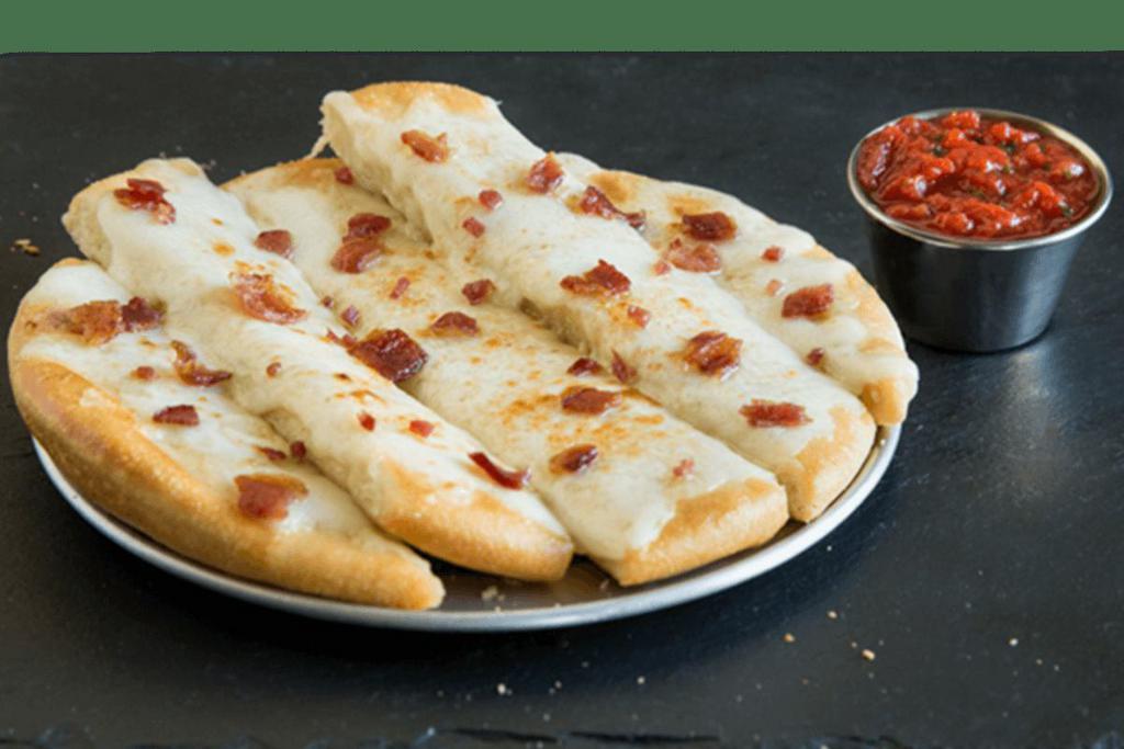Bacon Cheesy Breadstix · We took our cheesy breadstix to the next level and added savory pieces of bacon on top. You’re welcome. 8 inch.