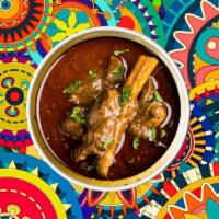 Homestyle Goat Curry · Succulent goat meat slow cooked in a classic brown curry, served with a side of our aromatic...