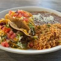Tex-Mex Tacos · 2 seasoned ground beef tacos served with Crispy Shells, sided by beans and rice, with grated...