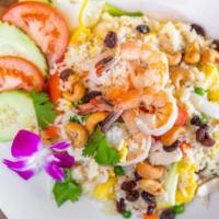 Pineapple Fried Rice · Chicken, shrimp, pineapples, toasted cashews, tomatoes, onions, scallions, raisins, peas and...