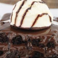 Double Fudge Chocolate Brownie · Chocolate brownie topped with a scoop of vanilla ice cream and chocolate sauce.