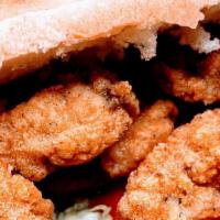 Oyster Po'Boy · fried Cajun Oysters, lettuce, tomatoes, pickles, spicy mayonnaise served on  French bread