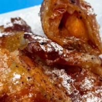 Peach Cobbler Eggroll  · Aunt bert's traditional peach cobbler filling deep-fried in an eggroll wrapper dusted with p...