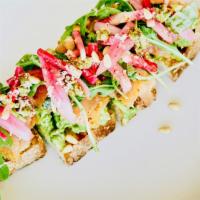 Smoked Salmon Avocado Toast* · Caper relish, watermelon radish, toasted pine nut, torn basil, pickled red onion, fresh hors...