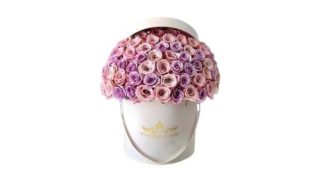 Signature Lavender & Pink Roses In A Box · Throughout history, roses have always been considered as the flower of elegance, love, romance and passion. This breathtaking design of Flower Boom Dallas Signature Rose Box is as elegant as it is romantic. Capture the essence of elegance, romance and passion with this stunning box of light pink Faith roses and lavender Ocean Song roses carefully put together with effort and detail one by one to create a smooth dome shape. The floral arrangement in the photo is 75 roses in our Medium size box.