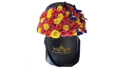 Signature Multicolor Roses With Butterflies · Bright and bold pink, orange and yellow classic roses are beautifully put together creating a Fbd dome shape and adorned with butterflies!

 Please be advised that we might used different color butterflies if the purple is not available.