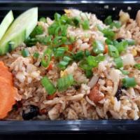 Pineapple Fried Rice · Stir-fried rice with scallions, tomatoes, carrots, raisins, and cashew nuts, pineapple and e...
