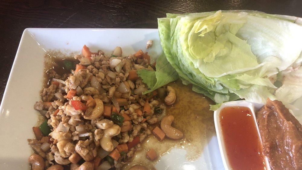 Thai Chicken Lettuce Wrap · A wrap served with lettuce, cilantro, and pineapple sauce chicken or tofu pan tossed with scallions and bell peppers served over crispy wonton noodles top with cashew nuts.