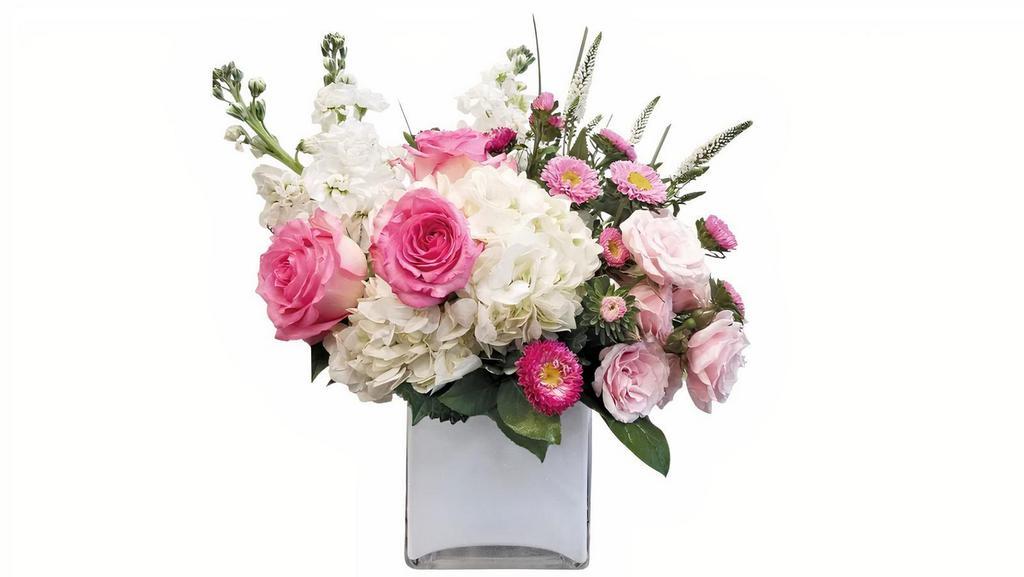 Pretty Lady Deluxe · This Pretty Lady consists of a white hydrangea, pink roses, fragrant stock and light pink spray roses designed in a beautiful white cube vase.

15