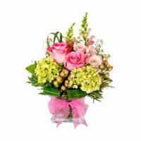 Pretty In Pink · Arrangement consisting of green mini hydrangea, pink roses, peach hypericum, and pink snaps....