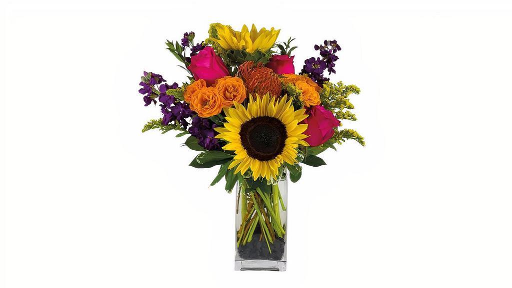 Fiesta  · Everyday's a party when you're surrounded by this bright and bold color pallet. Sunflowers, orange spray roses, pink roses, protea and stock create a fun and festive floral presentation.

15