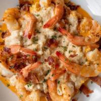 Shrimp & Grits · grilled gulf shrimp on smoked gouda grits, with tabasco shallot butter sauce, topped with ba...