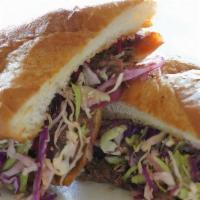 Bbq Brisket Sandwich · smoked & chopped texas brisket, pickled red onion, cabbage slaw & tangy house bbq sauce on b...