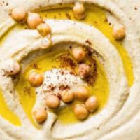 Hummus · Mashed chickpeas mixed with tahini sauce and spices 
with one pita bread .