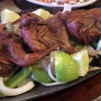 Quail · Three quails, served with rice, charro beans, pico de gallo and guacamole