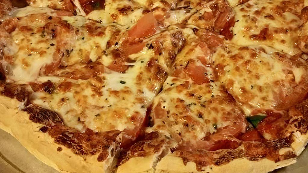 Margarita Pizza · Fresh basil, shredded mozzarella and
tomatoes