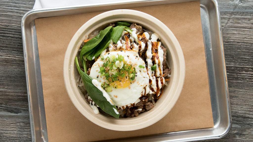 Beef Bulgogi Bowl · Rice topped with Korean barbecued marinated tender beef, mixed veggies, stir fried glass noodles, pan fried egg and Korean BBQ sauce.