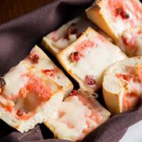 Pink Bread · French bread with sun-dried tomato spread and melted Mozzarella.