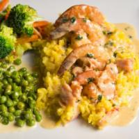 Risotto Arragosta · Saffron rice with lobster, topped with sautéed shrimp and smoked salmon, served the American...