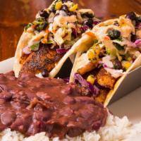 Togo Fish Tacos · Blackened White Fish served with Cajun Slaw and Black Bean Corn Relish. Drizzled in Chipotle...
