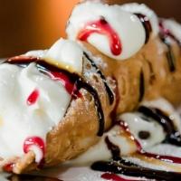 Cannoli · Cinnamon shell pastry stuffed with sweet ricotta cheese cream & chocolate chunks. Dusted wit...