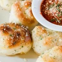 Garlic Knots · House-made dough, buttered, sprinkled with spices and baked to perfection. Served with our f...