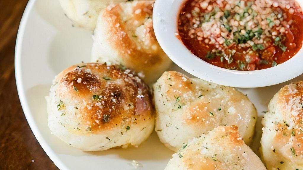 Garlic Knots · House-made dough, buttered, sprinkled with spices and baked to perfection. Served with our freshly made marinara sauce. Available in half or full dozen.