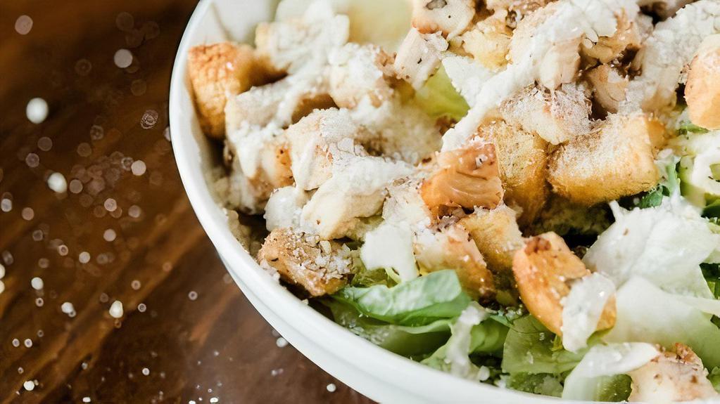 Chicken Caesar Salad · Romaine lettuce, croutons, parmesan cheese, and caesar dressing topped with diced grilled chicken.