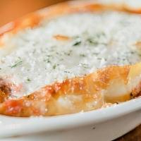 Baked Lasagna · Layers of pasta, ricotta cheese, mozzarella cheese, ground beef, and marinara baked in a dis...