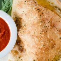 Cheese Calzone · Oven-baked dough stuffed with ricotta and mozzarella cheese. Brushed with garlic butter and ...