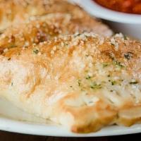 Meat Stromboli · Oven-baked dough stuffed with pepperoni, sausage, hamburger, Canadian bacon, bacon, and mozz...