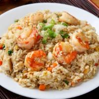 Fried Rice · Stir-fried rice in a wok with assorted vegetables.