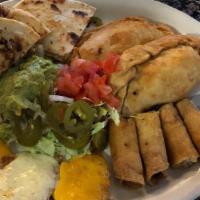 Poco De Todo · Sample platter served with chicken fajita quesadillas, chicken flautas, beef empanadas, bean...