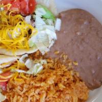 Puffy Tacos Plate · Two puffy tacos filled with ground beef or shredded chicken, topped with lettuce, tomato, an...