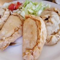 Empanadas Plate · Two fried flour tortillas stuffed with ground beef or shredded chicken. Served with Spanish ...