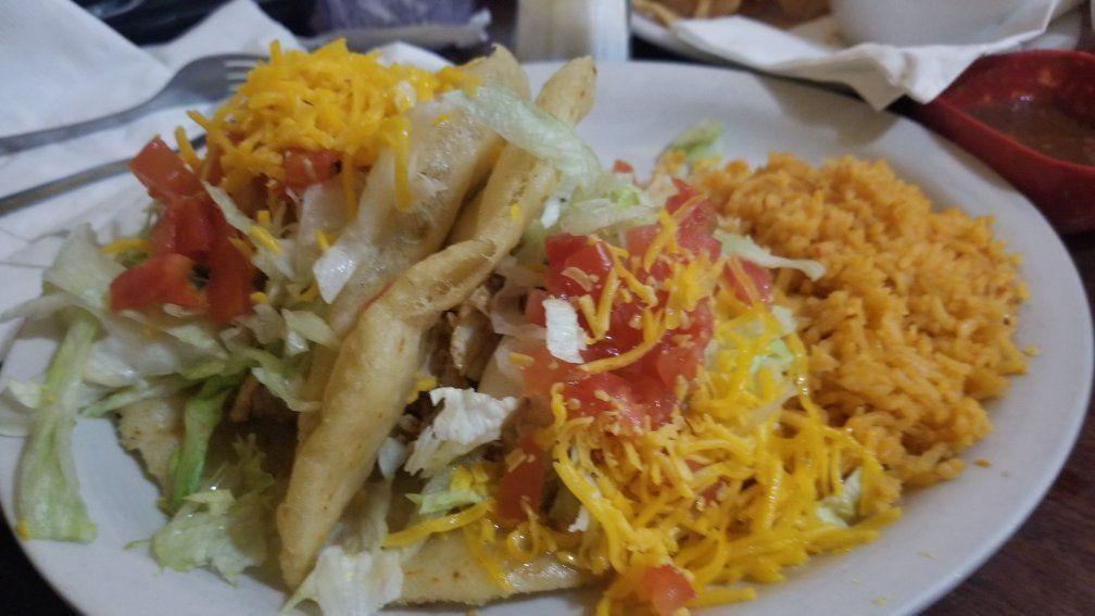 Crispy Tacos Plate · Two crispy tacos filled with ground beef or shredded chicken, topped with lettuce, tomato, and shredded cheese. Served with Spanish rice and choice of beans.