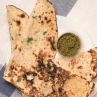 Garlic Naan · Topped with spices.