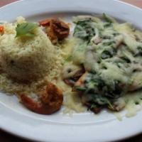 Shrimp And Spinach Enchiladas · Two enchiladas topped with tomatillo salsa served with white rice and black beans.