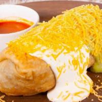 Chimichanga Plate · With beans & cheese inside, topped with guacamole, sour cream & cheddar cheese.
