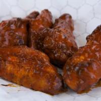 Wings · Cooked wings of a chicken coated in sauce or seasoning.