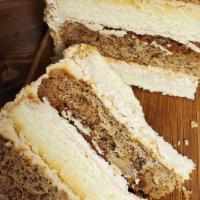 Italian Cream Cake Slice · Layers of moist white cake with pecans, and a hint of cinnamon with Italian cream cheese ici...
