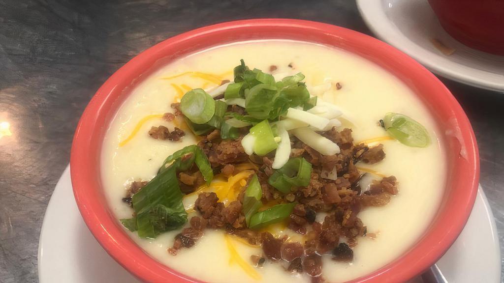 Baked Potato Soup · Creamy potato soup topped with cheddar cheese, bacon bits and green onions.